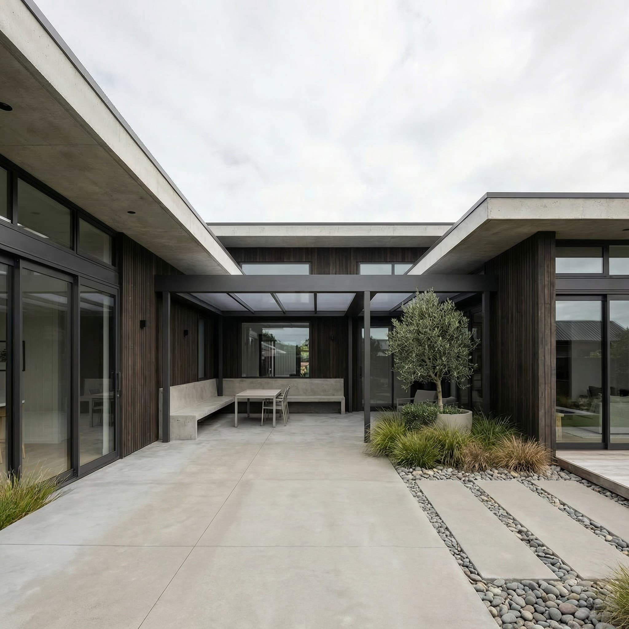 Fixed acrylic roof within a dark box-perimeter pergola