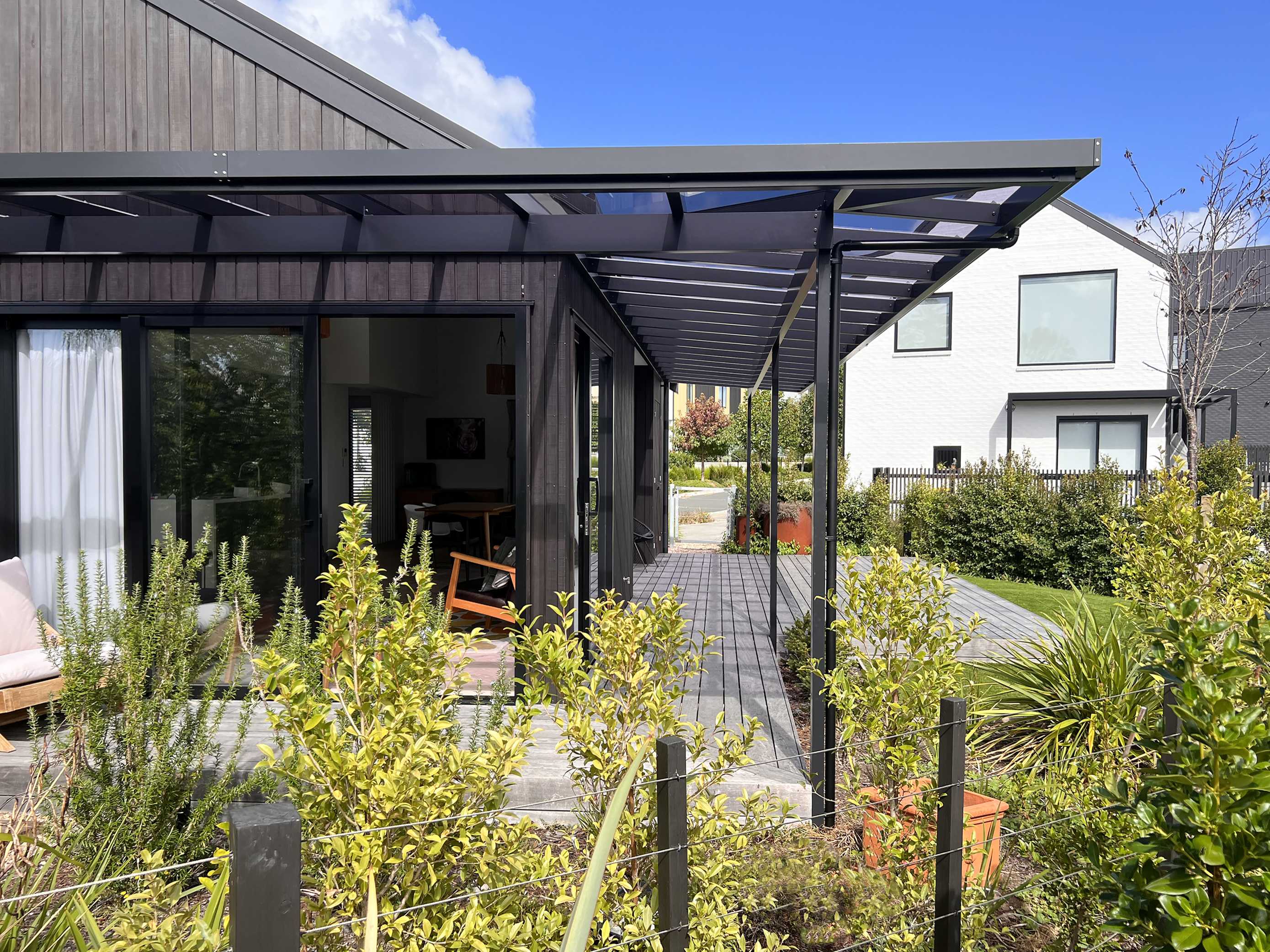 Exterior view of a hip pergola showing several roof planes