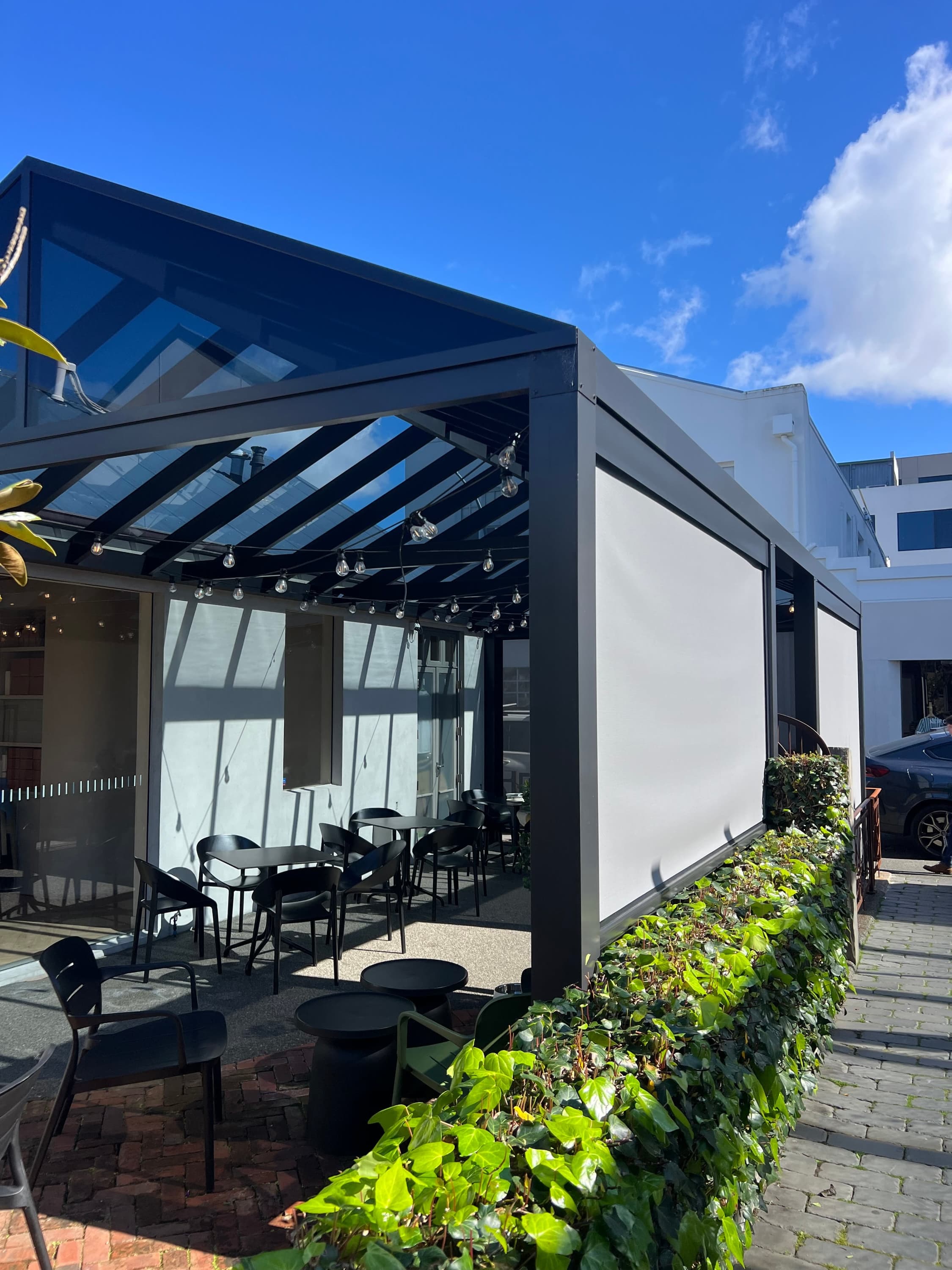 Sheltered outdoor seating beneath the Atelier Shu Cafe canopy