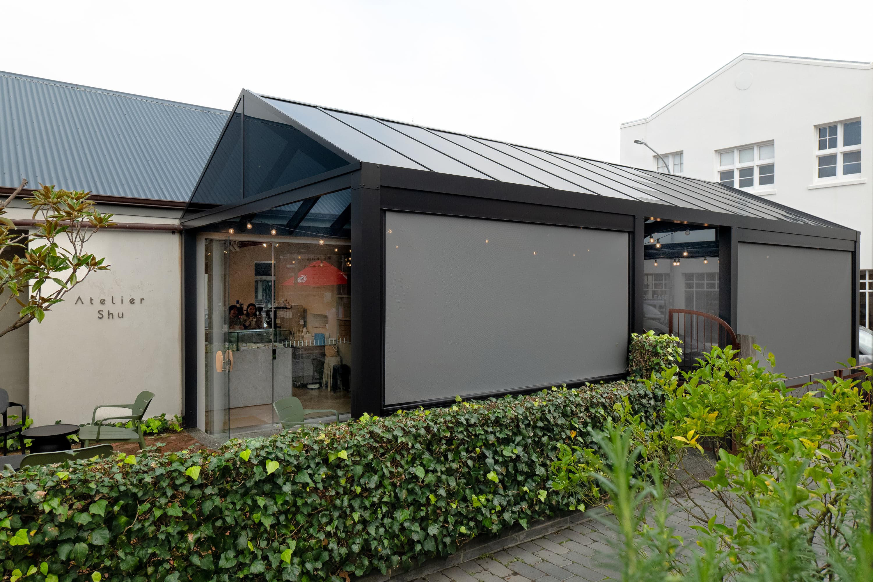Wide view of the Atelier Shu Cafe canopy and integrated blinds