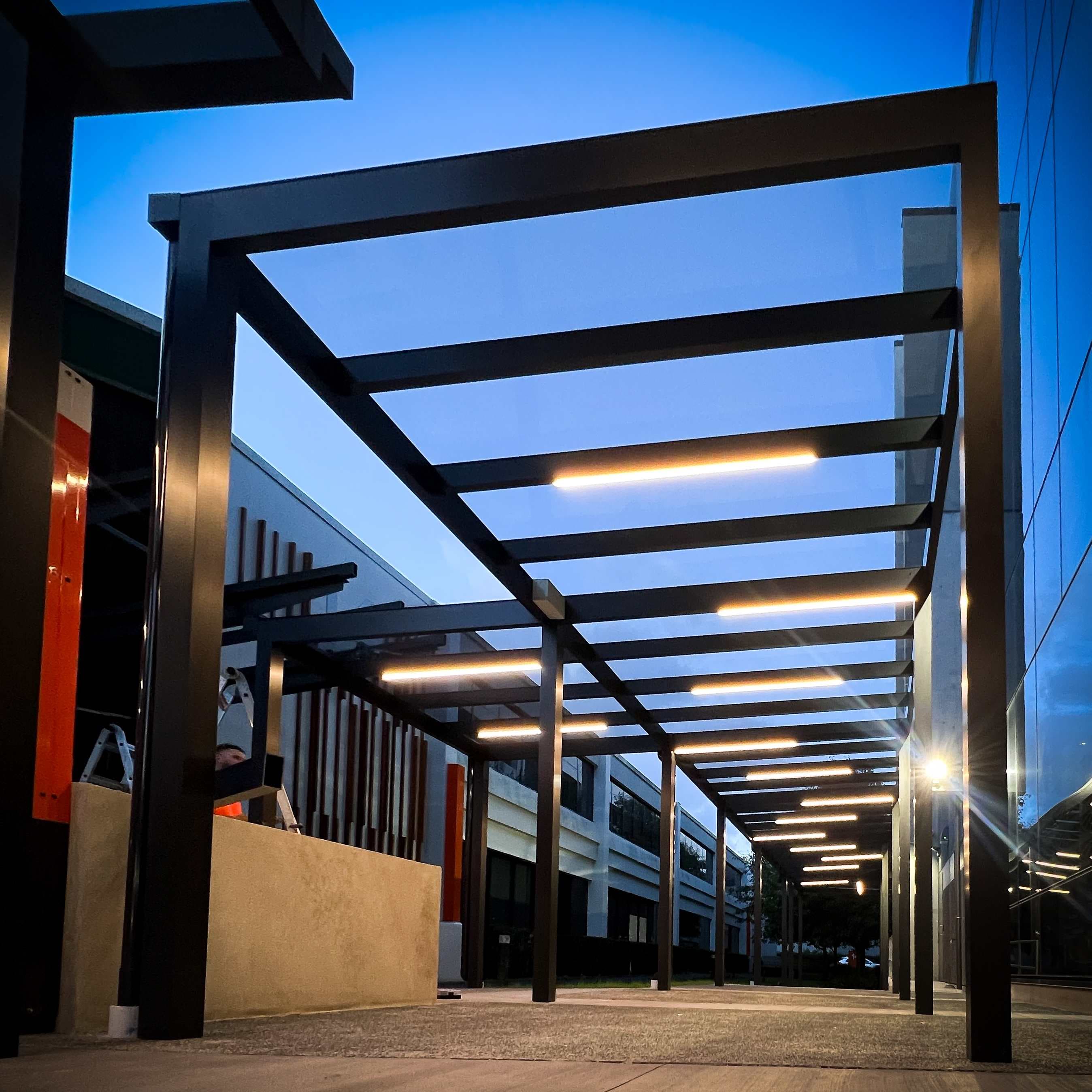 Integrated strip lighting along the KiwiRail workplace canopy at night