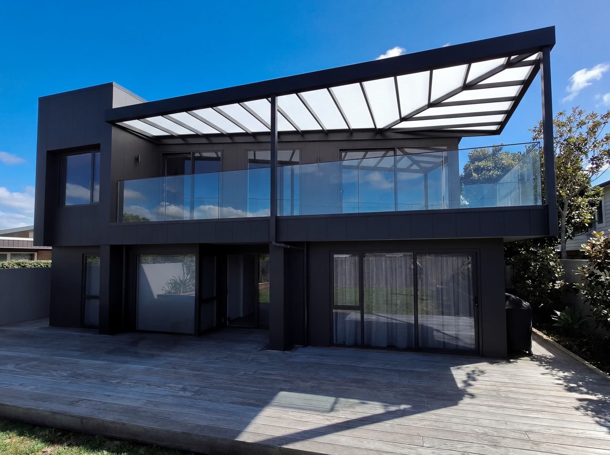 Front view of the Mt Maunganui first-floor deck cover with dark aluminium framing