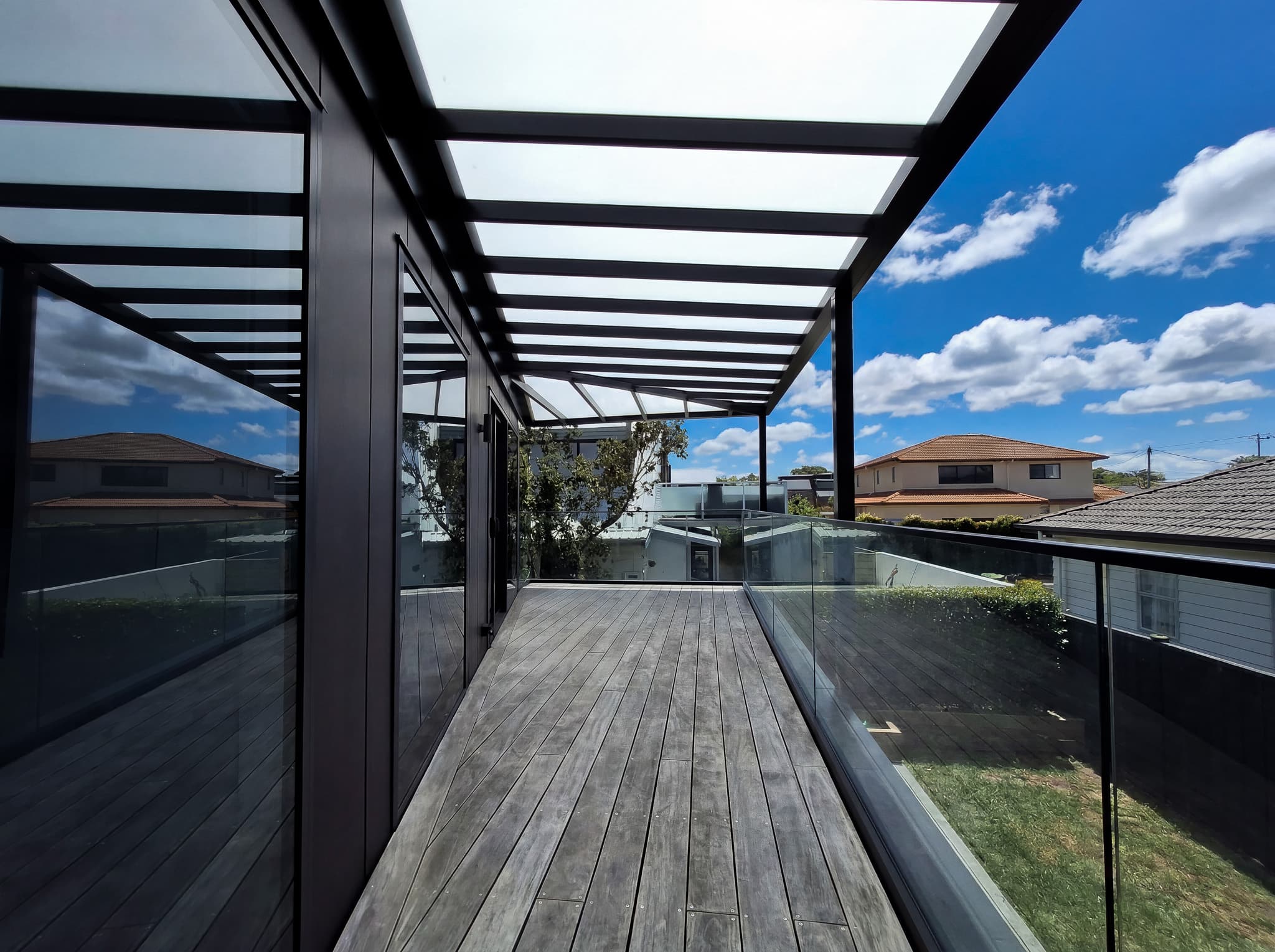 View beneath the opal acrylic pergola roof along the first-floor deck at Mt Maunganui