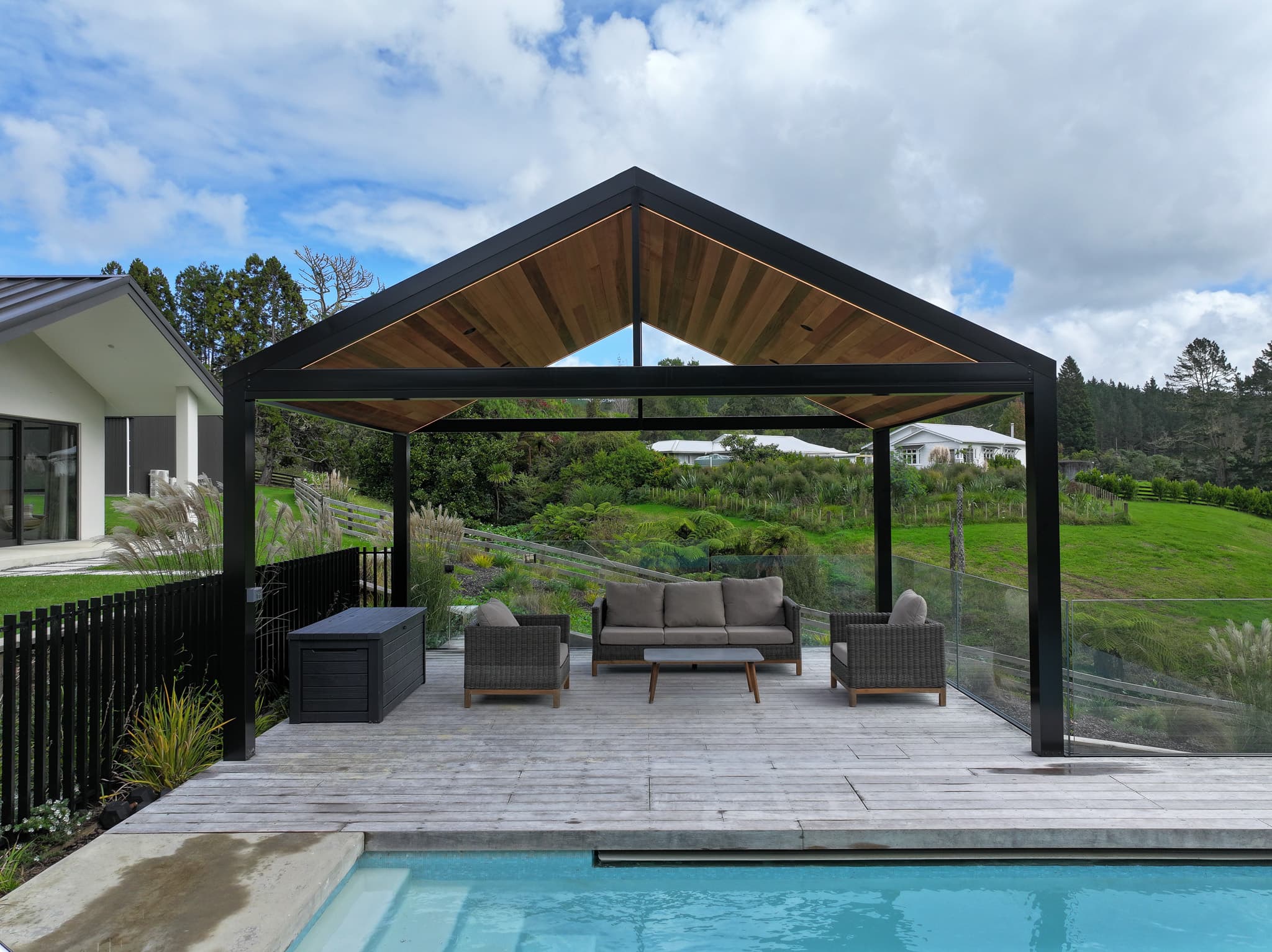 Riverhead gable pavilion beside a pool and garden