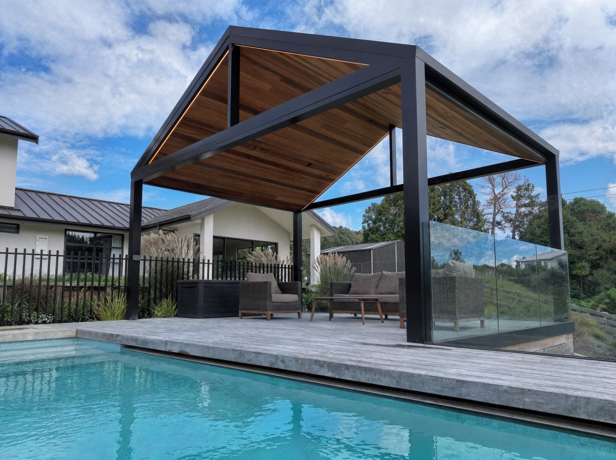 Side view of the Riverhead poolside pavilion showing the gable roof and timber-lined underside