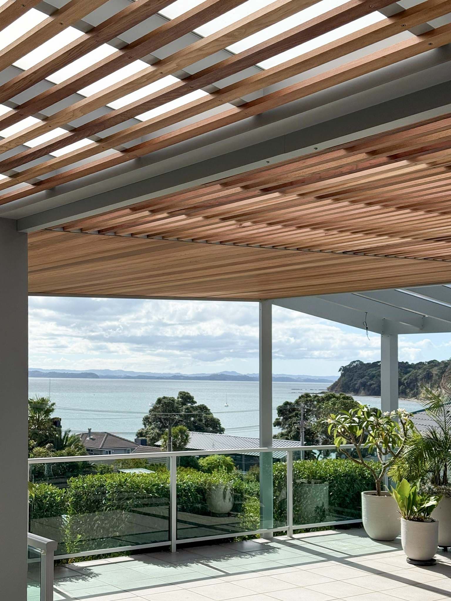 Timber battens, acrylic roof zones and the coastal outlook at Tindalls Bay