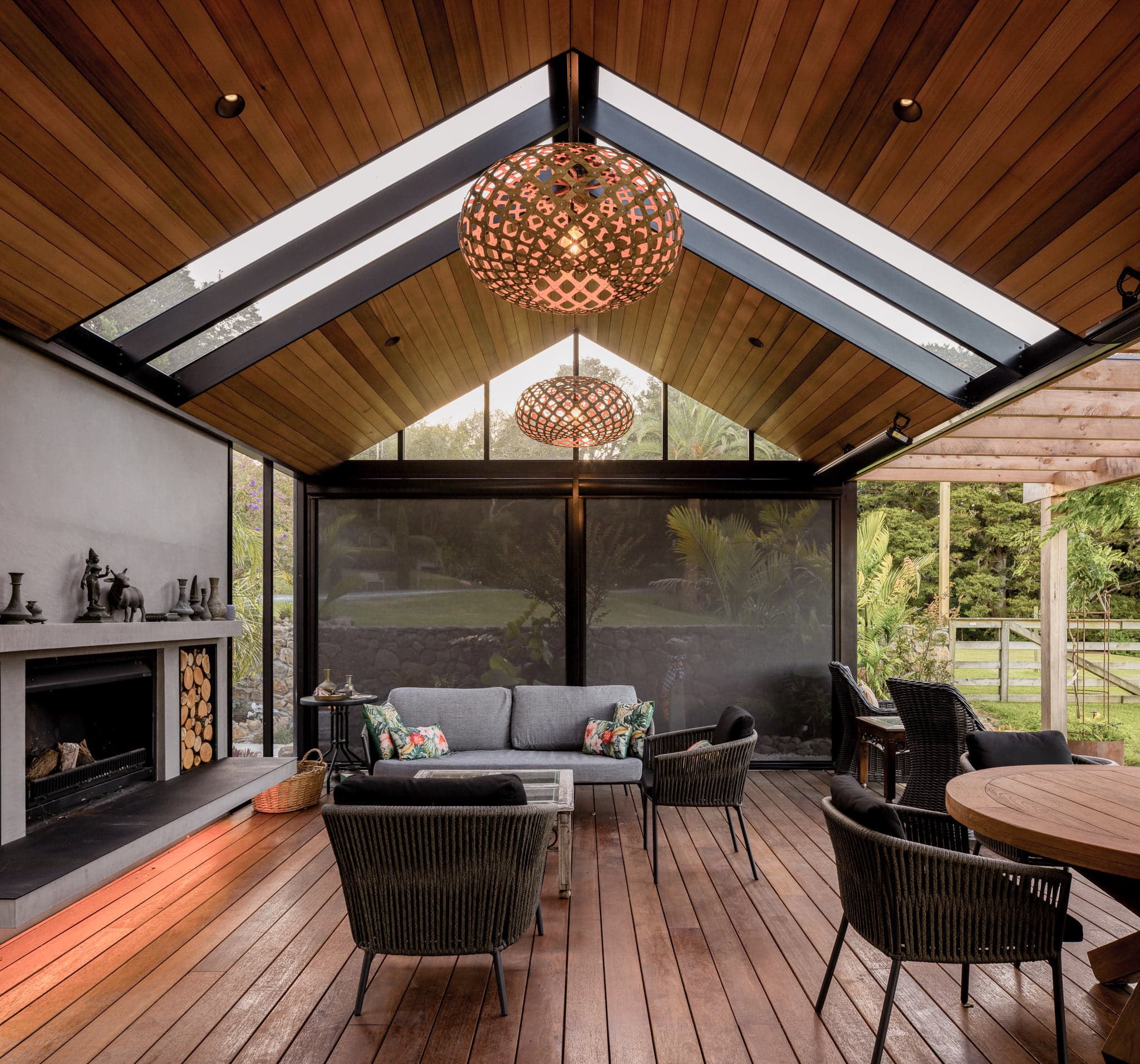 Interior outdoor room with cedar ceiling, pendant lighting and lounge seating