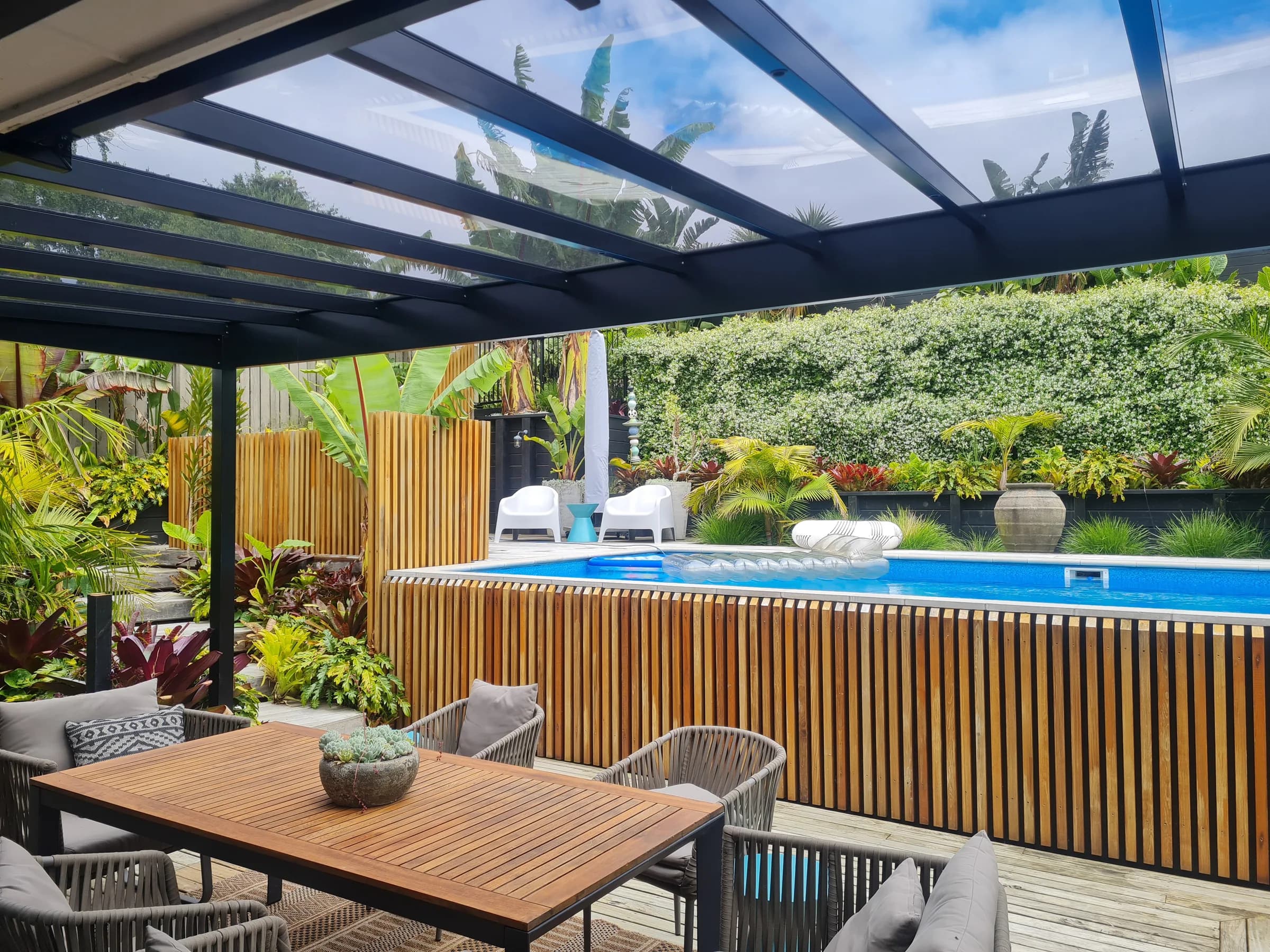 Pitched acrylic pergola preserving daylight over an outdoor living space